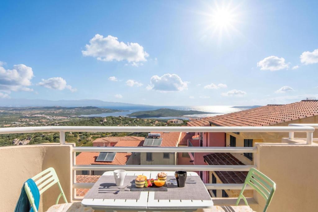 a table on a balcony with a view of the ocean at Elicriso - Happy Rentals in San Pasquale