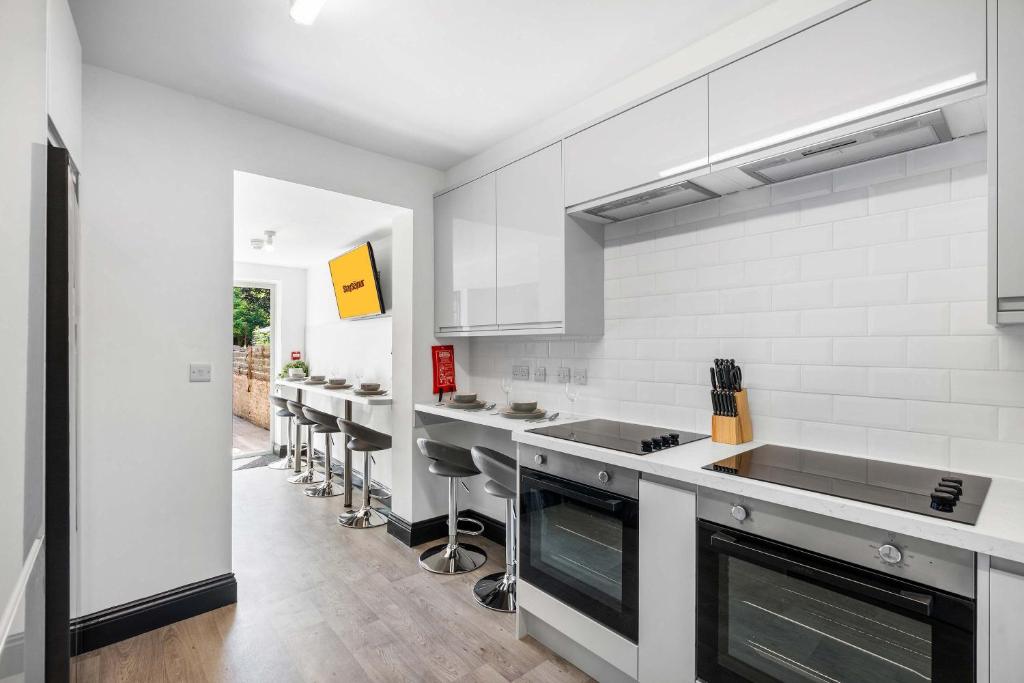 a kitchen with white walls and white counter tops at Large 6-Bed House - 5 Bathrooms w Free Parking by StaySejour in Sompting