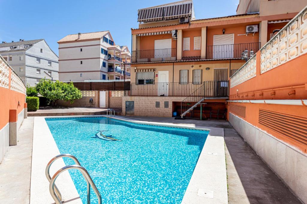 a swimming pool on the side of a building at Lopimar Aurora in Canet de Berenguer