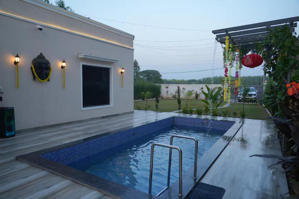 a swimming pool in the backyard of a house at Angad Farms in Kharar