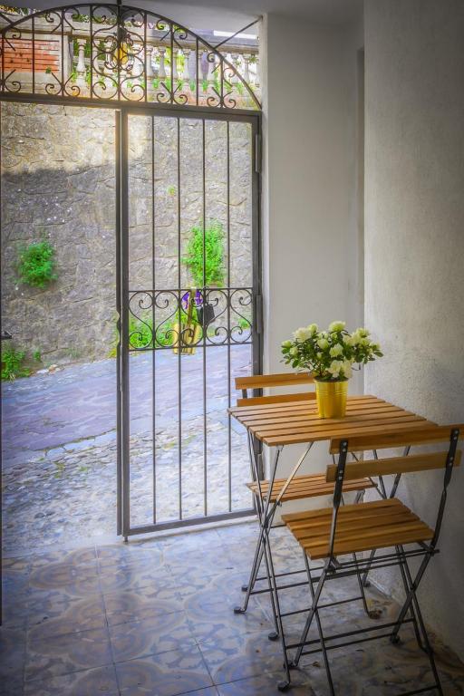 an open door to a patio with a plant on a table at La Colombaia Bed and Rooms in Belvedere Marittimo
