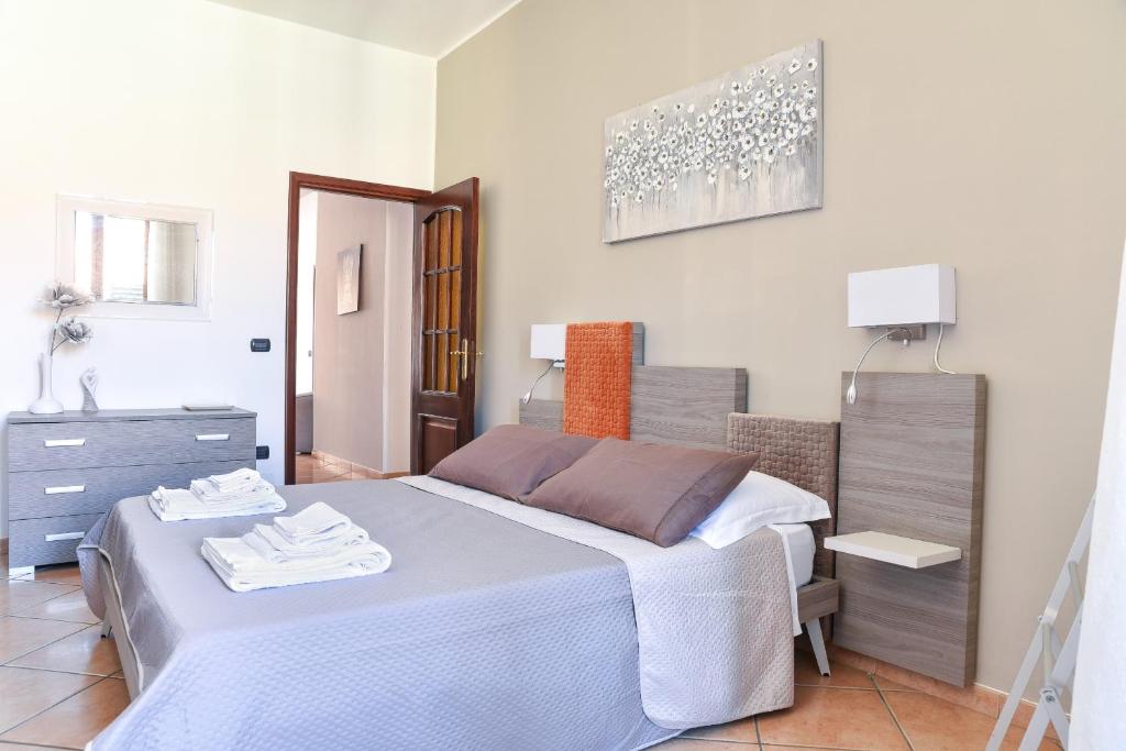 a bedroom with a bed and a dresser at La Casa di Birba in Acquedolci
