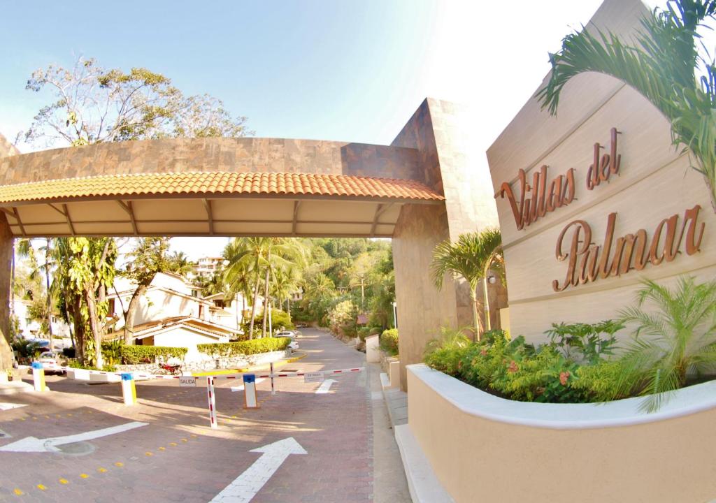 a sign for the villa el palacio resort at Villas del Palmar Manzanillo with Beach Club in Manzanillo