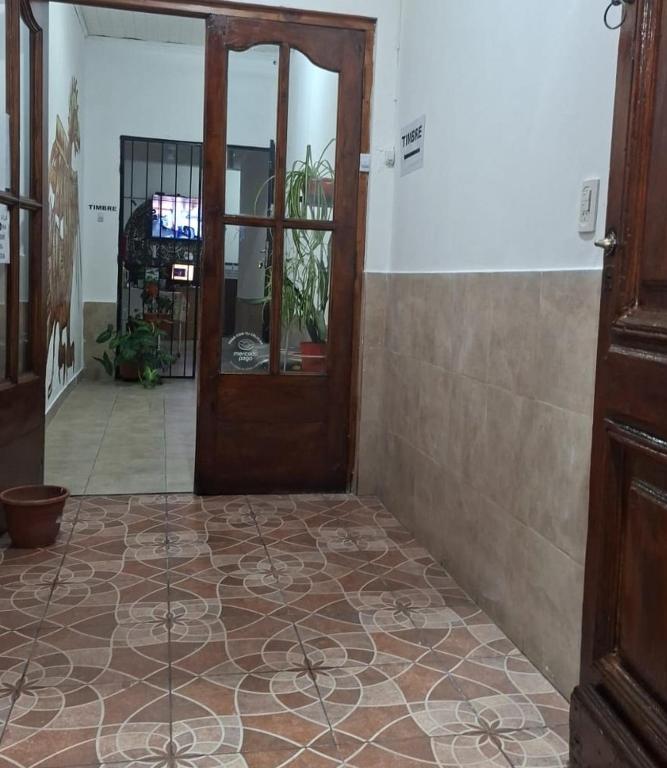 a room with a door and a tile floor at Hostal AMALAYA in Salta