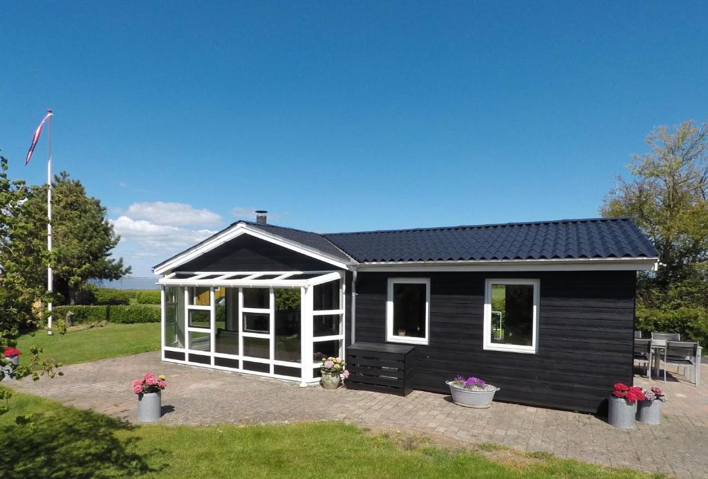 a black and white tiny house with windows at Top Modern Holiday Home 100 M From The Baltic Sea in Nordborg