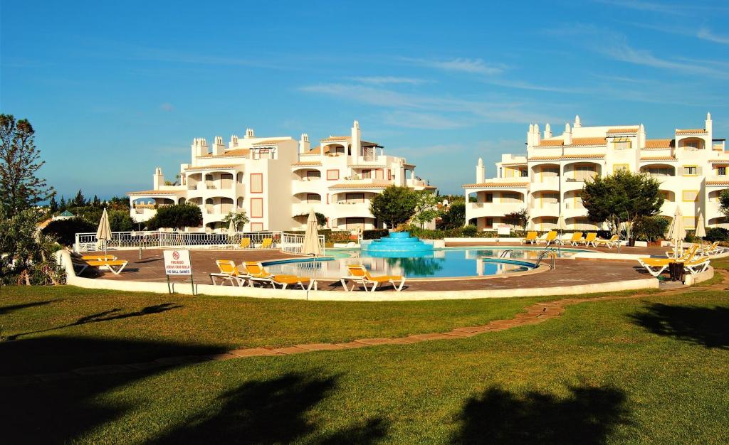 a resort with a swimming pool and two large buildings at Vilamoura Apartment in Vilamoura