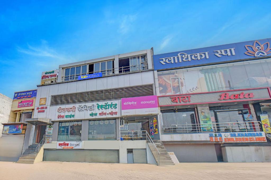 a building with signs on the side of it at Via Kamal Stay Inn in Alandi