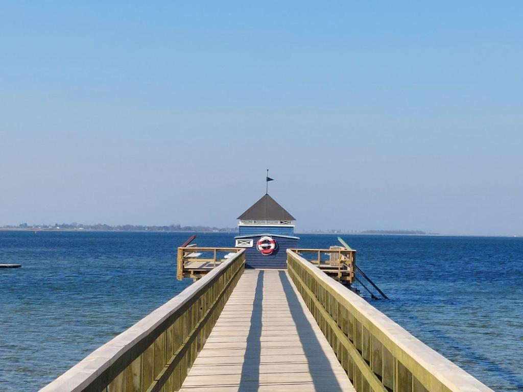 a lighthouse on a pier in the water at Cozy Central Located Townhouse In Nakskov in Nakskov