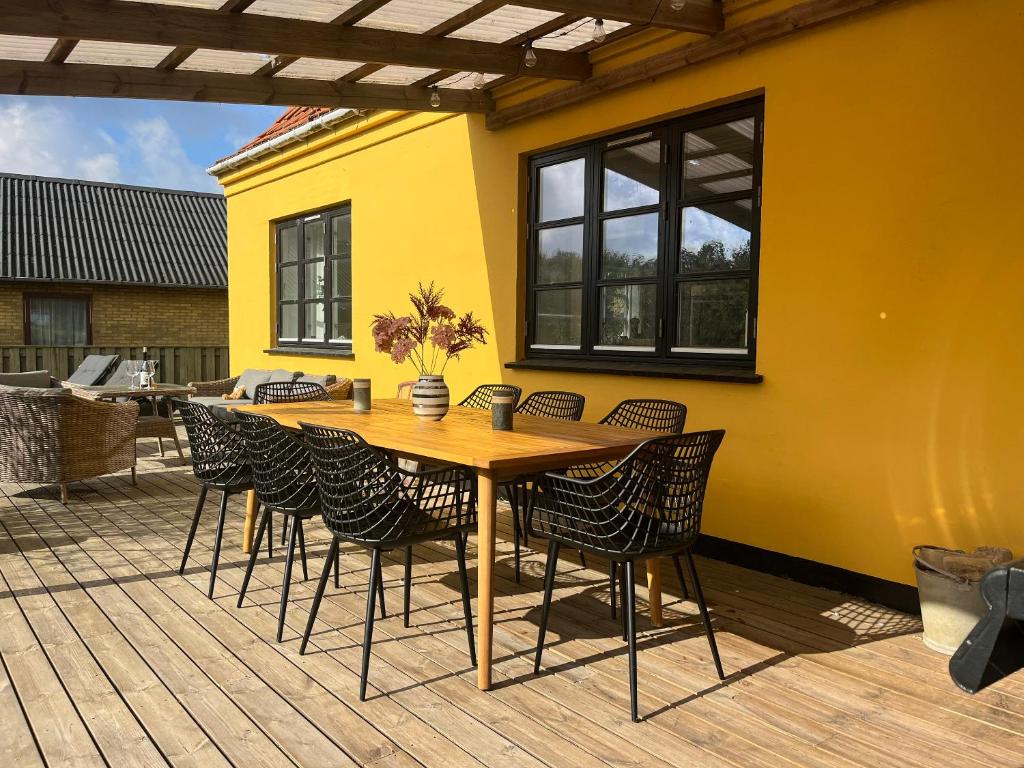 a wooden table and chairs on a patio at Lovely Spacious Holiday Home On Bornholm in Hasle