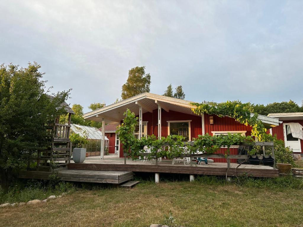 a house with a deck with plants on it at Family Friendly Holiday Home In Orø in Holbæk