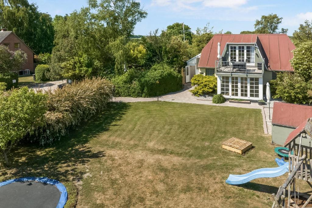 an aerial view of a yard with a playground at Child-Friendly Cottage With Large Indoor Pool in Otterup
