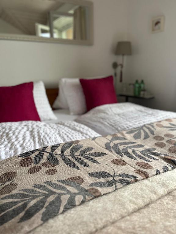 a bed with a blanket on top of it at B&B Alpenblick in Erlinsbach