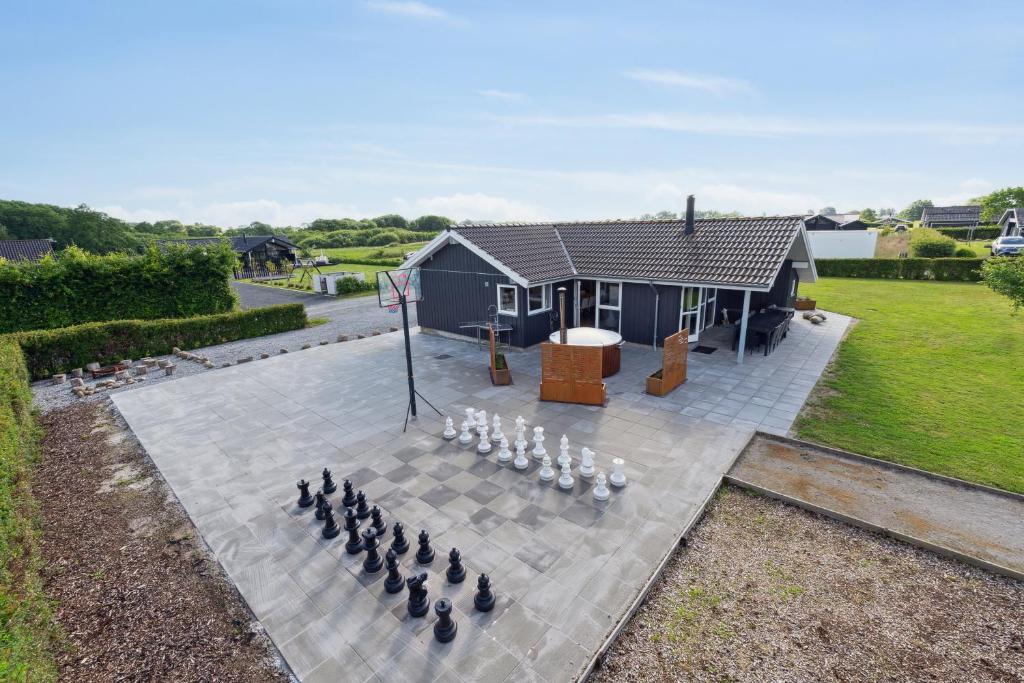 a house with a group of chickens on a patio at Activity House - Flovt Strand Haderslev in Haderslev