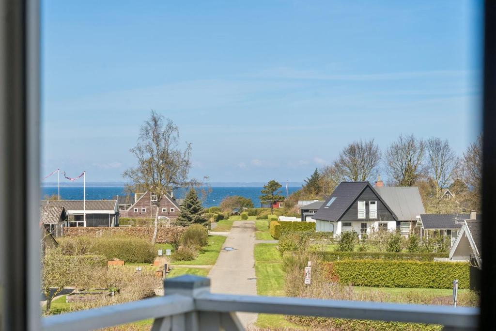 a view from a window of a village with houses at Cozy Central House Near The Sea in Brenderup