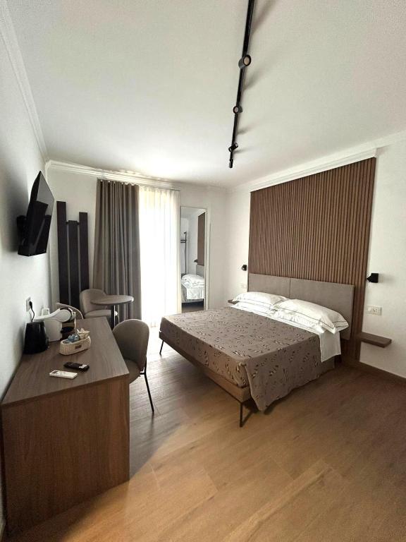a bedroom with a bed and a desk in it at I Cordari B&B in Vieste