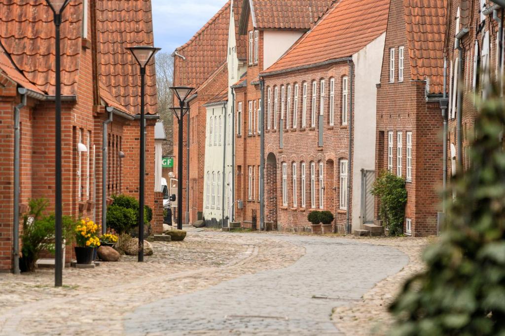 an empty street in a town with brick buildings at Cozy Apartment In Tønder in Tønder