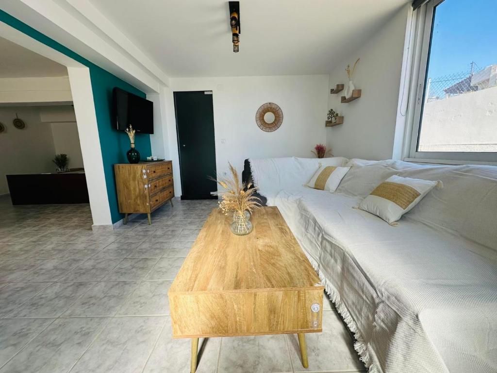 a living room with a bed and a coffee table at infinity sky stay in episkopi-heraklion