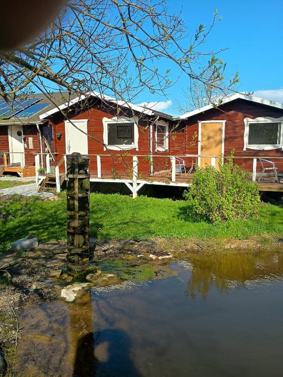 a house with a lake in front of it at Charming Summer House In An Idyllic Area in Gylling