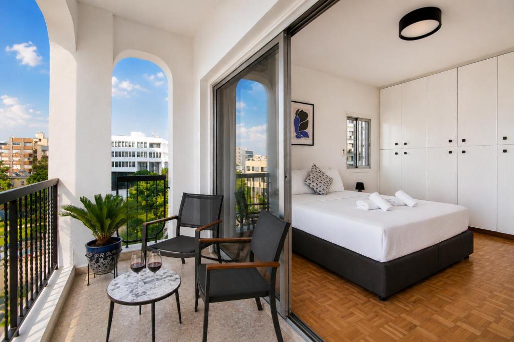 a bedroom with a bed and a balcony at Urban Condo Promitheos in Nicosia