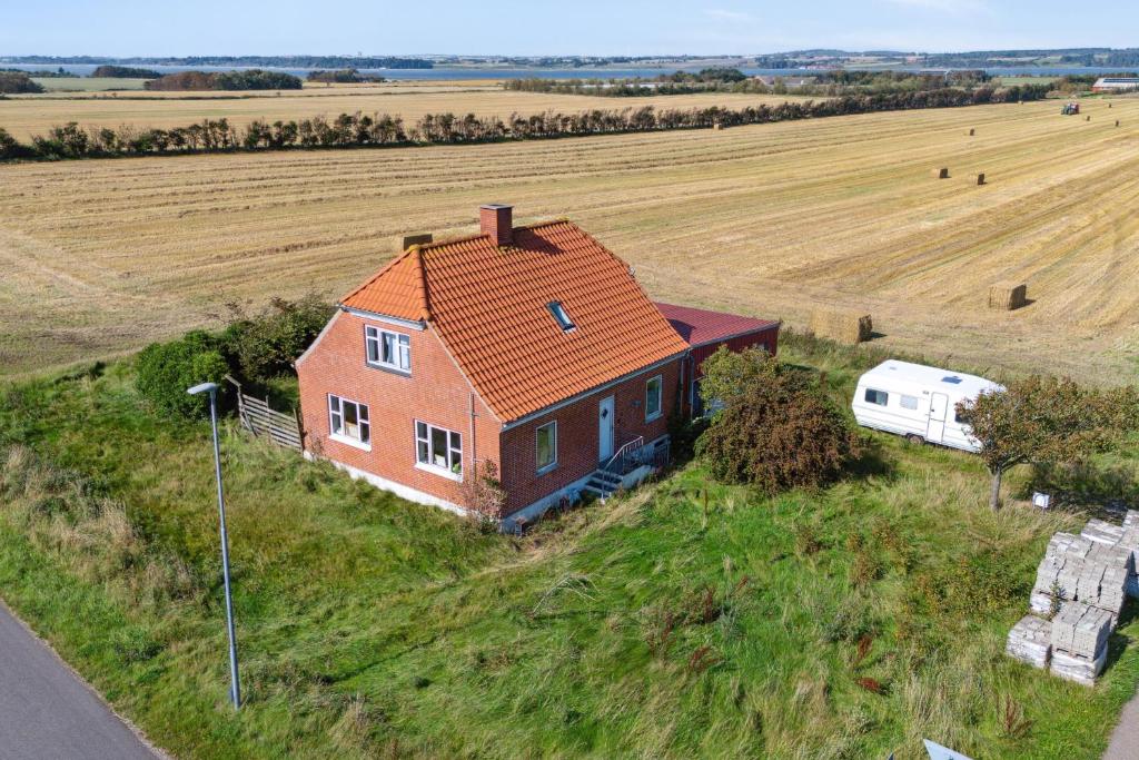 an aerial view of a house and a rv in a field at Summer House In Thyholm in Thyholm
