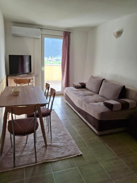 a living room with a couch and a table at Apartment Moki in Lastva