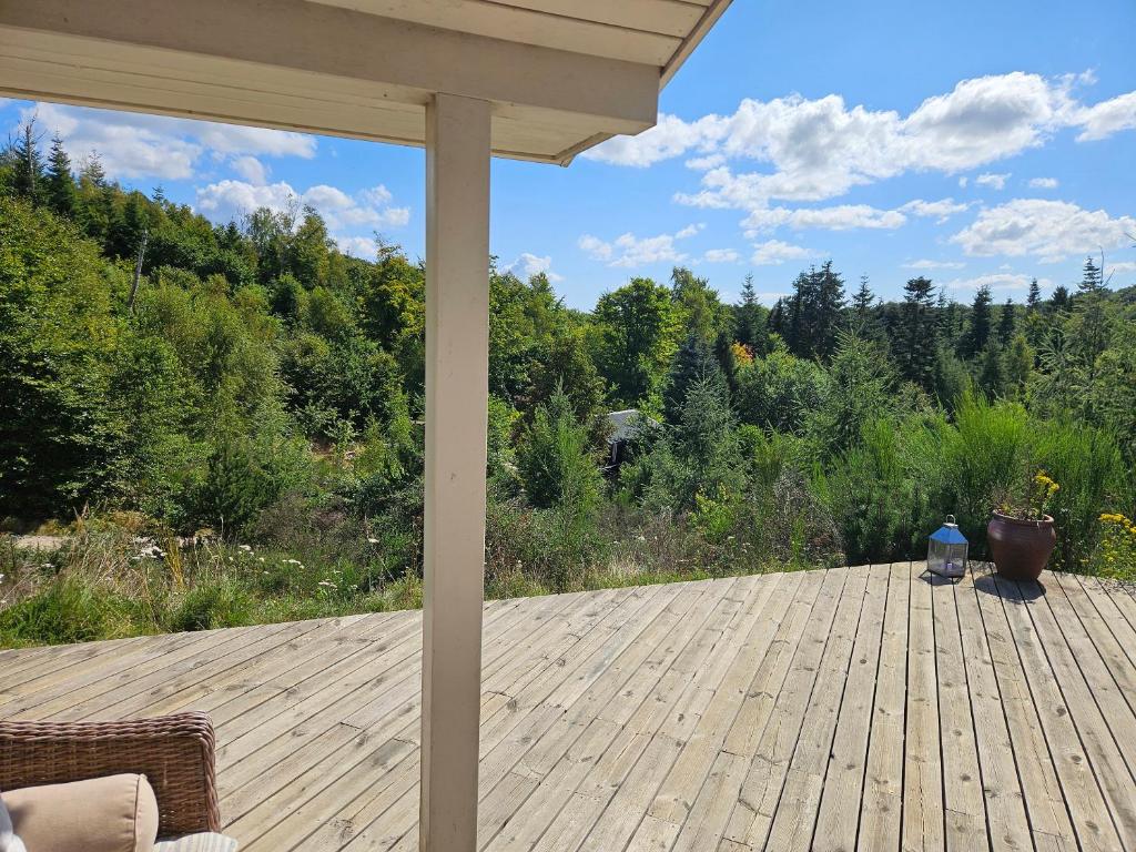 a wooden deck with a view of a forest at Fantastic House With A Beautiful View in Ebeltoft