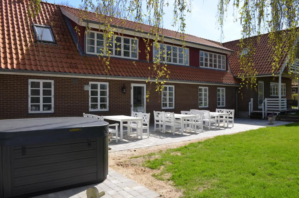 a building with a table and chairs in front of it at Large Holiday Home In Seaside Hotel Style in Ans