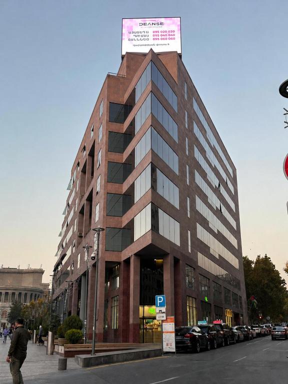 a tall building with a sign on top of it at BM Avenue Hotel in Yerevan