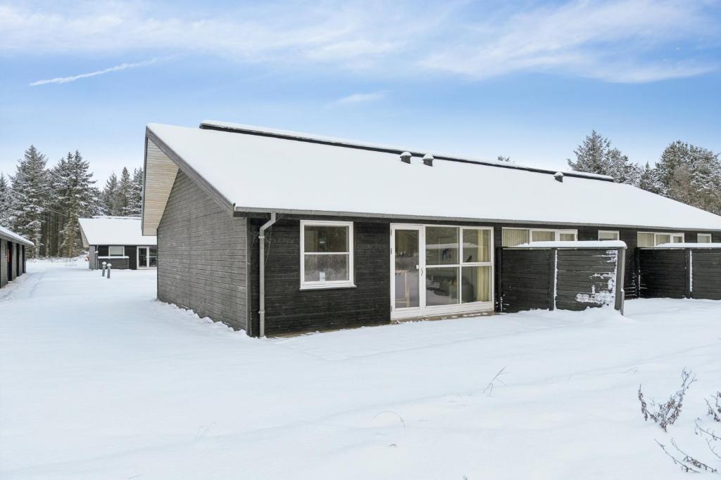a house with a snow covered yard at Holiday Close To Beach Golf And Café in Pandrup