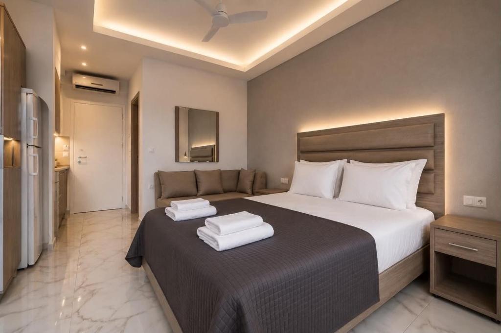a bedroom with a bed with two towels on it at Calua SeaView Rooms in Kriopigi
