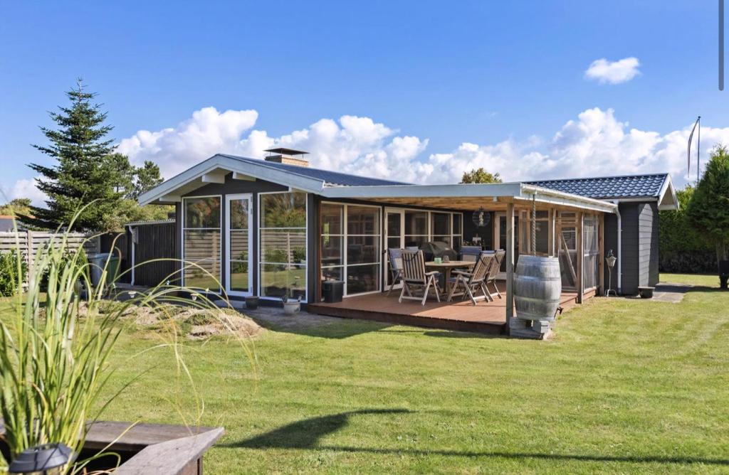 a pavilion with a table and chairs in a yard at Close To The Beach With Outdoor Spa in Slagelse