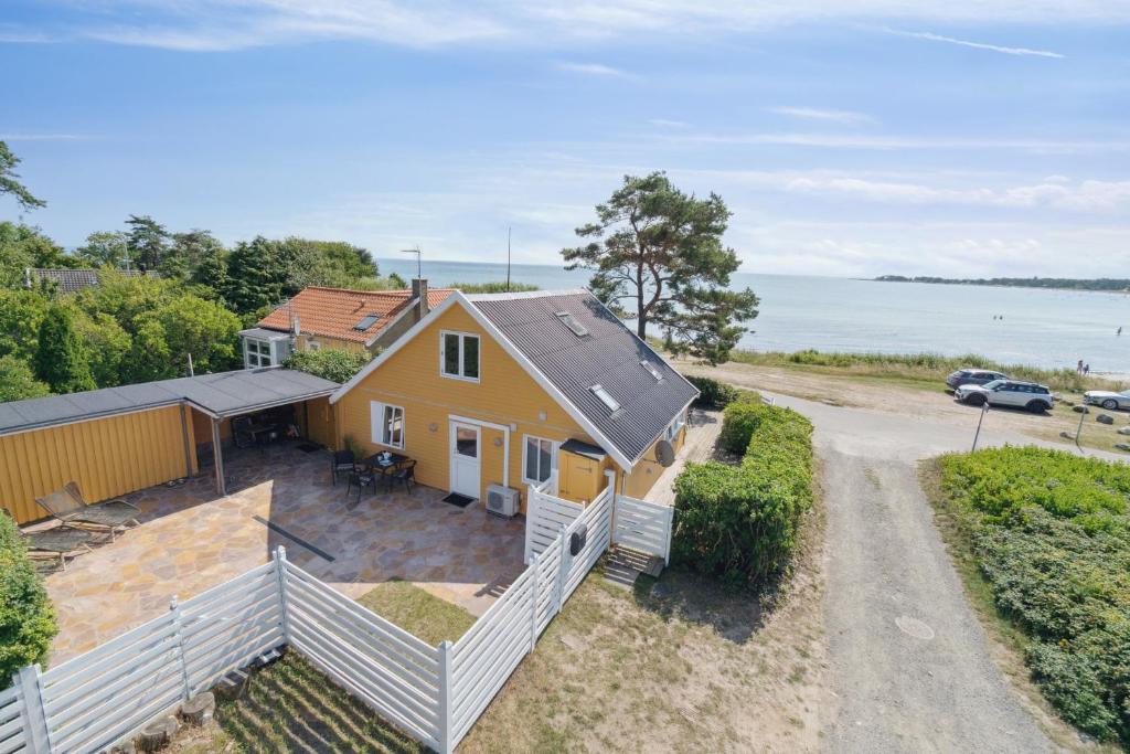 an overhead view of a yellow house with a driveway at Panoramic View And Denmarks Best Beach in Neksø