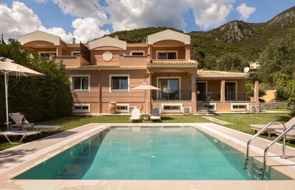 a villa with a swimming pool in front of a house at Villa Renata -Pool, Large Garden & Free Parking, 2 Minutes Walk from The Beach in Barbati