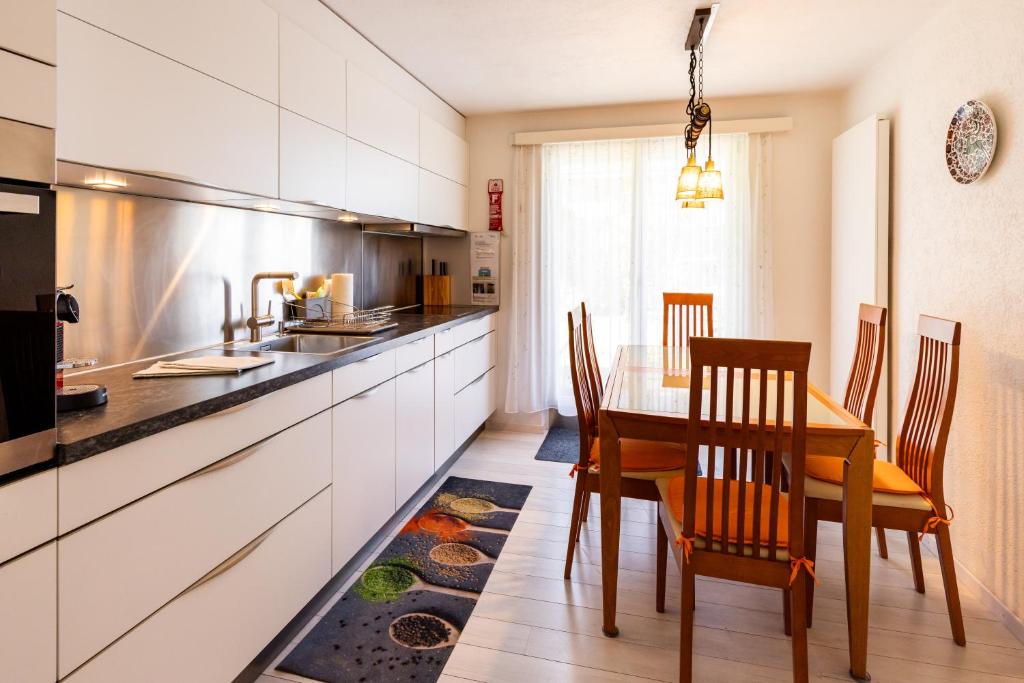 a kitchen with a wooden table and a dining room at Hauswurz in Thun