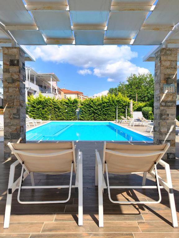 a pool table and two chairs on a patio at Luxury Suite Gala in Nikiti