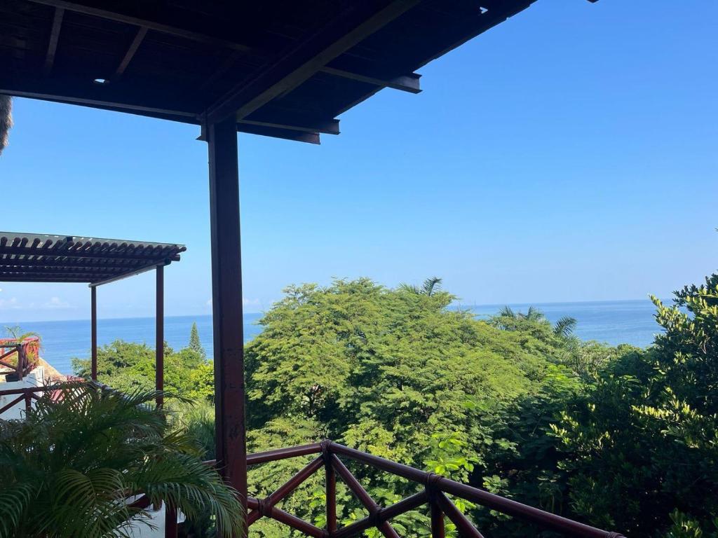 a view of the ocean from a house balcony at Condo Solana Oceanview and Jungle Bliss! in Sayulita