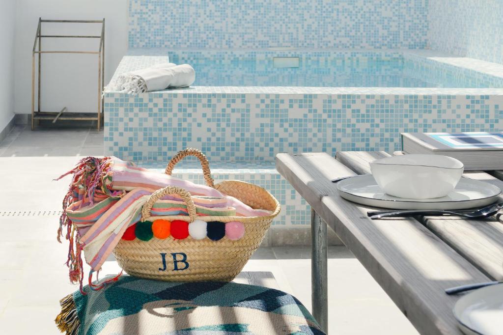 a basket sitting on a table next to a pool at Casa Alegra in Carvalhal