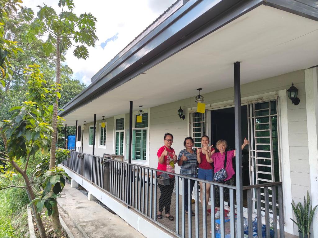 a group of people standing on a porch of a house at Homestay House - Tamparuli in Tamparuli