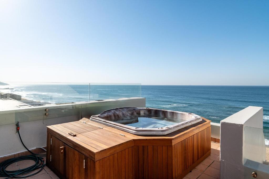 a hot tub on a balcony with a view of the ocean at Chaka Terraces 10 in Ballito