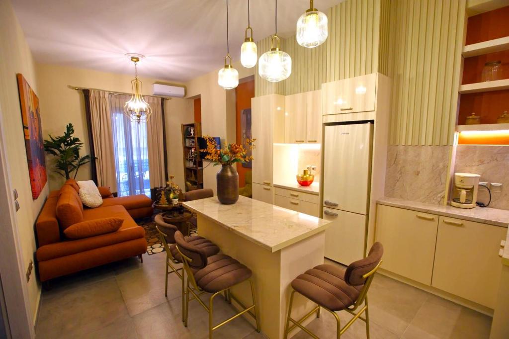 a kitchen with a table and chairs and a couch at Chrysiida Luxury Apt, Stroll to Nafplio Center in Nafplio