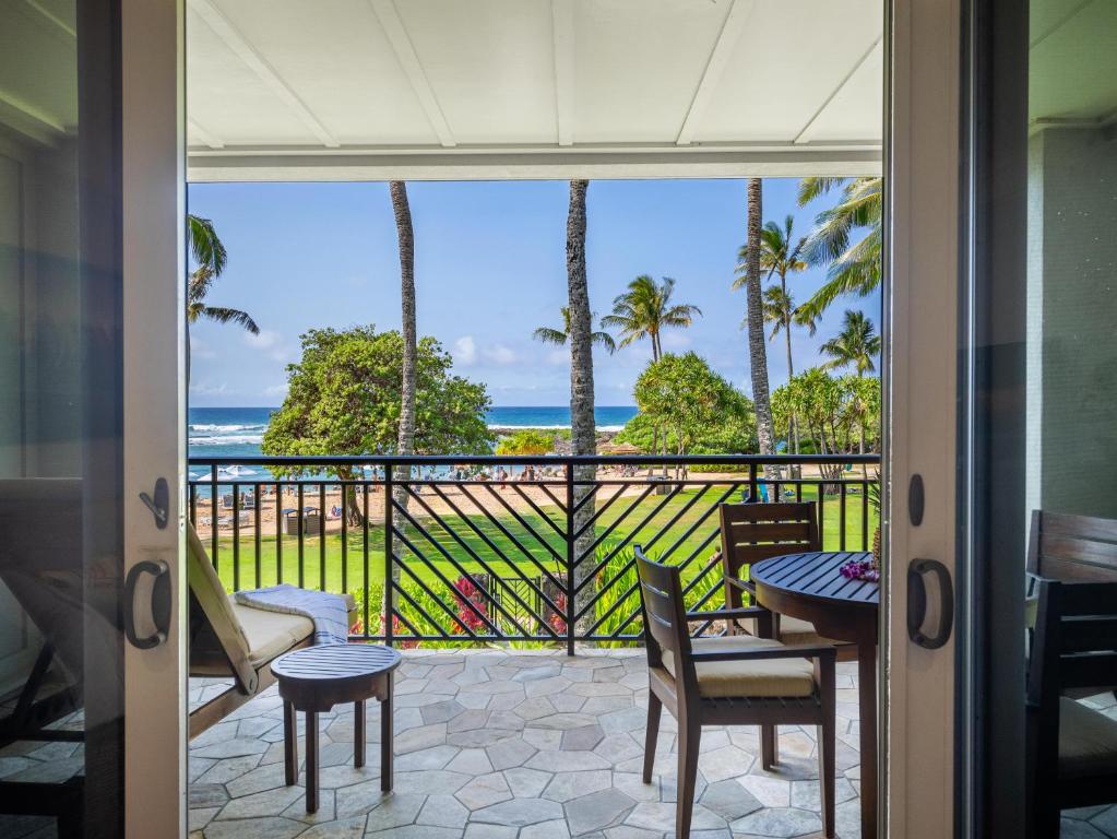 a room with a balcony with a view of the ocean at 3-Bed Villa 203 at Turtle Bay in Kahuku