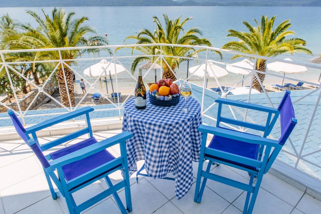 a table with a bowl of fruit and a bottle of champagne at Μeltemi in Glífa