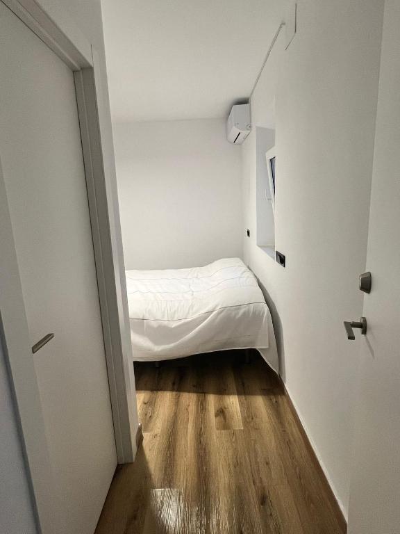 a small bedroom with a bed in a small room at Casa Arrabal Villa in Salobreña