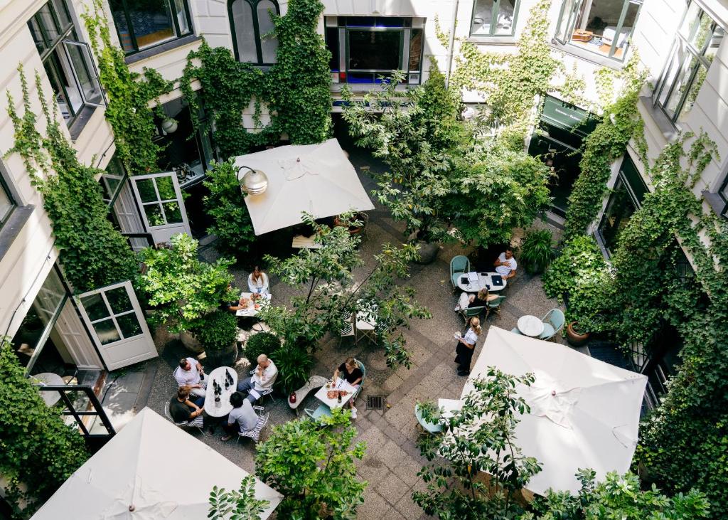 an overhead view of a courtyard with people sitting at tables at Coco Hotel in Copenhagen