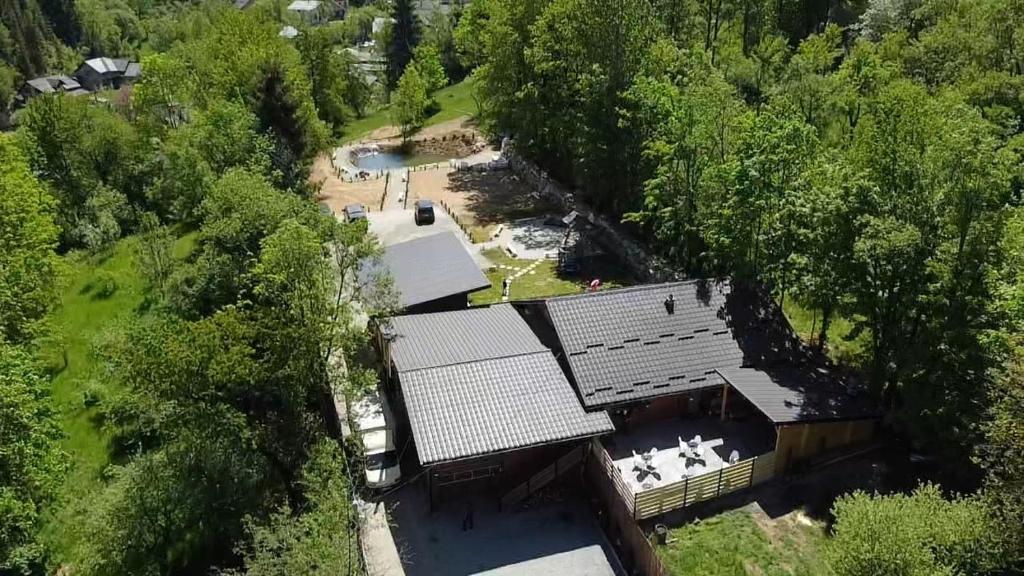 an aerial view of a building in the woods at Cabana La Conac in Borşa