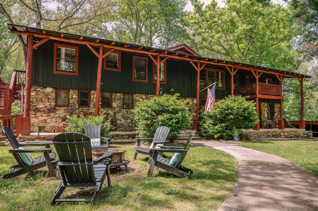 a house with rocking chairs in front of it at Wildrest Hotel in Waynesville