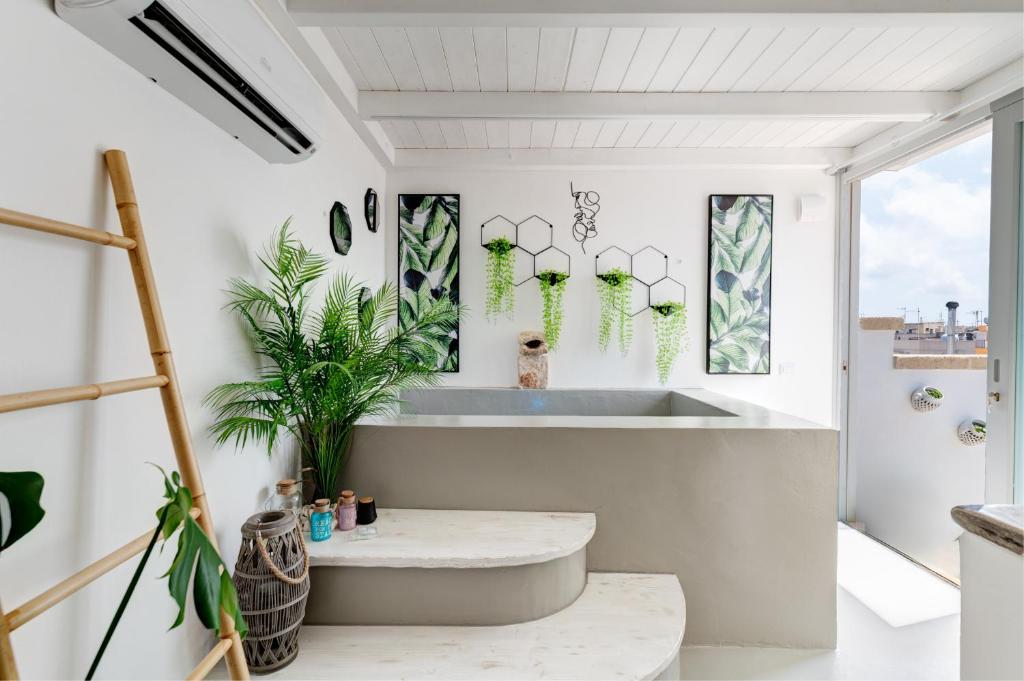 a bathroom with a tub and a window at Gente di Mare Luxury Home in Fasano