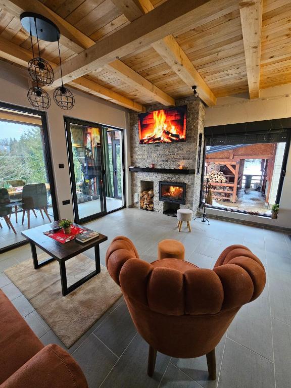 a living room with a couch and a fireplace at Brvnara Tarin osmeh - u srcu Nacionalnog parka Tara in Sekulić 