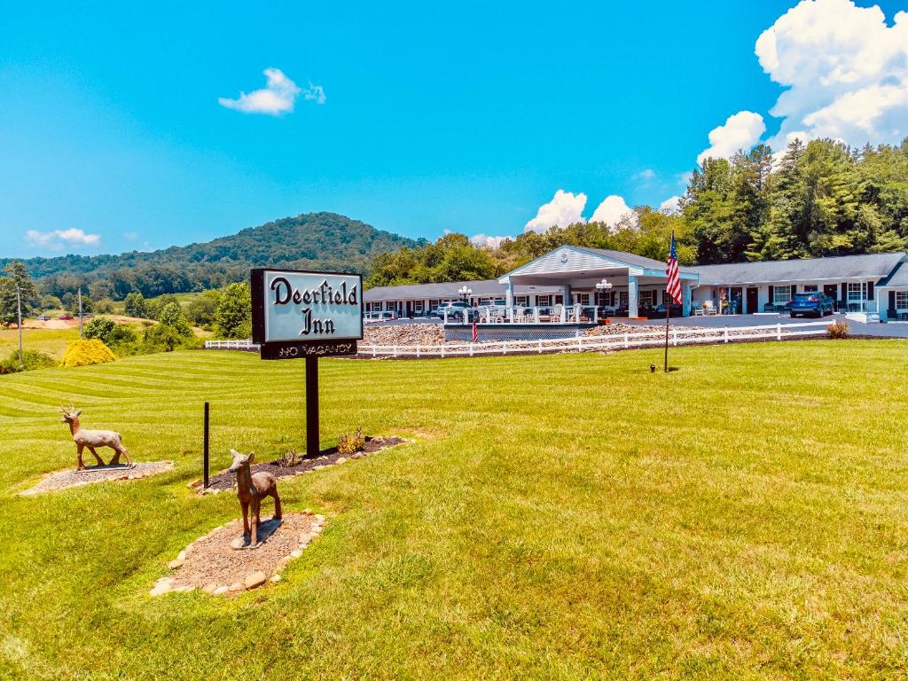 a sign with two animals standing in a field at Deerfield Inn - Virtual Check In in Hayesville