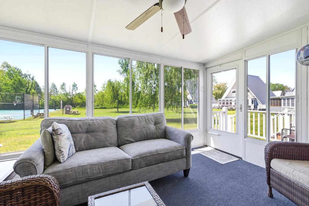 a living room with a couch and large windows at Chalet #57 in Stevensville